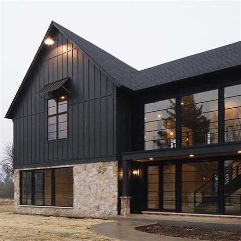 white barndominium with black trim